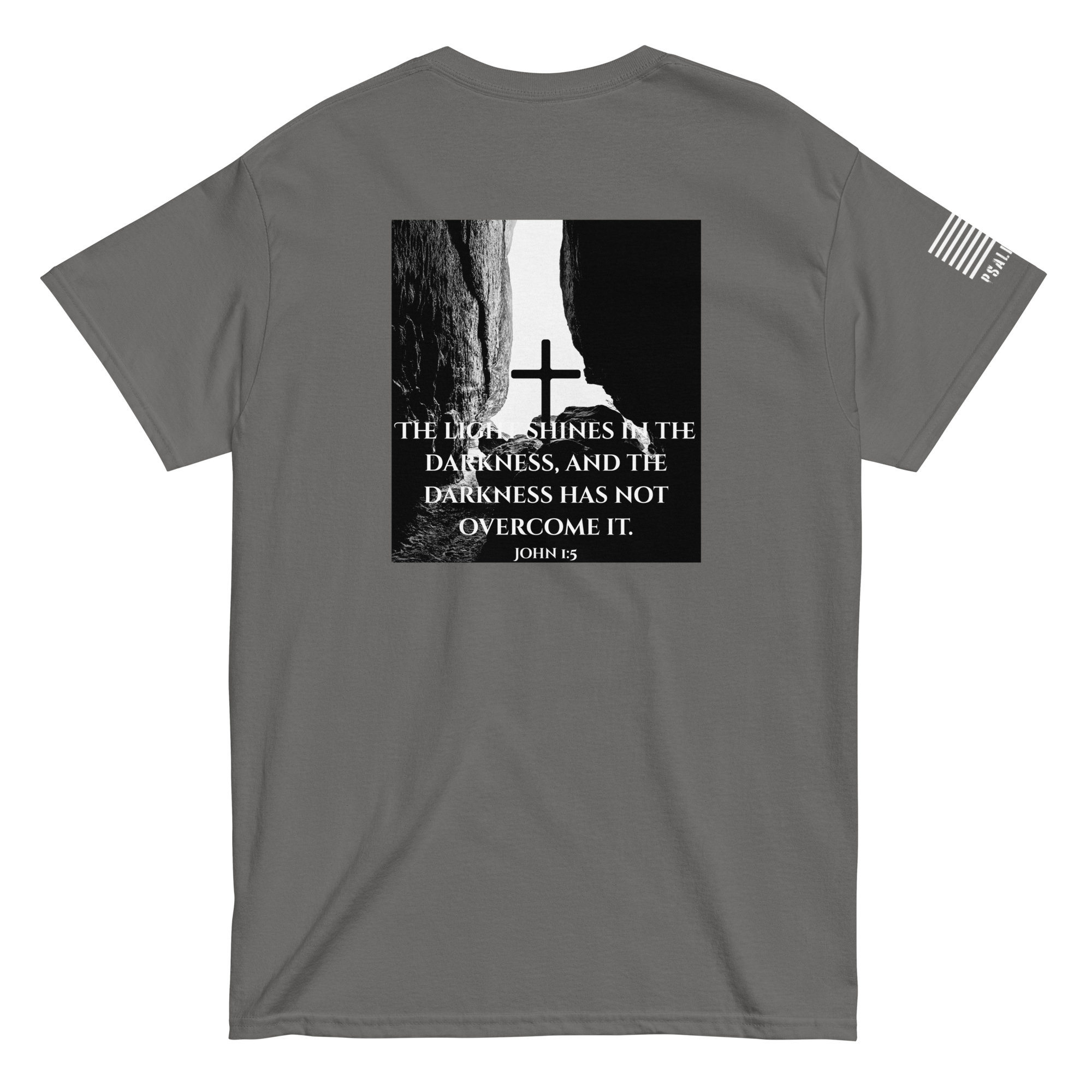 Faith-based tee from FFO’s Narrow Path Collection — features cross illuminated by light breaking through cave darkness, symbolizing John 1:5